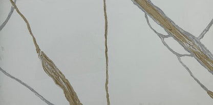 Close-up of a marble-like tile with gold and gray veins on a white background